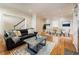 Spacious living room flowing into dining area with hardwood floors, detailed trim and neutral paint at 111 Paces Run, Atlanta, GA 30339