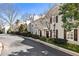 Street view of attractive townhomes featuring manicured shrubs, trees, and stucco facades at 111 Paces Run, Atlanta, GA 30339