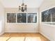 Bright sunroom with hardwood floors, a chandelier, and large windows with a view of the surrounding nature at 111 Paces Run, Atlanta, GA 30339