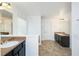 The bathroom is nicely appointed with double sinks and dark wood cabinets at 3129 Arbor Oaks Dr, Snellville, GA 30039