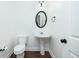 Charming powder room features pedestal sink, oval mirror, and modern fixtures at 3129 Arbor Oaks Dr, Snellville, GA 30039