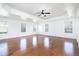 Spacious bedroom featuring hardwood floors, trey ceiling, a ceiling fan and large windows at 3129 Arbor Oaks Dr, Snellville, GA 30039