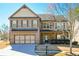 Charming two-story home featuring a brick and stone facade, attached two-car garage, and manicured lawn at 3129 Arbor Oaks Dr, Snellville, GA 30039
