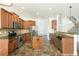 Spacious kitchen featuring a central island, stainless steel appliances, and warm wood cabinetry at 3129 Arbor Oaks Dr, Snellville, GA 30039