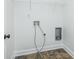 Bright laundry room featuring tile floors and a wire storage rack for organization at 3129 Arbor Oaks Dr, Snellville, GA 30039