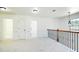 Bright upstairs loft area with neutral carpeting, windows and decorative railing at 3129 Arbor Oaks Dr, Snellville, GA 30039