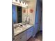 Bathroom with double sinks, granite countertops and decorative flower accents at 83 Nyishol Way, Dallas, GA 30157