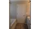 Bathroom view showcasing bathtub, granite vanity, and wood-look flooring at 83 Nyishol Way, Dallas, GA 30157