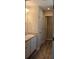 Bright bathroom with double sinks, granite countertops and plank flooring at 83 Nyishol Way, Dallas, GA 30157