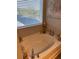 Relaxing bathtub nook with a large window, providing natural light and creating a serene atmosphere at 83 Nyishol Way, Dallas, GA 30157