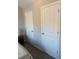 Bedroom featuring neutral walls and carpet with view of closet and additional door at 83 Nyishol Way, Dallas, GA 30157