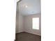 Small bedroom with angled ceiling, neutral carpet and a window at 83 Nyishol Way, Dallas, GA 30157