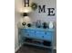 Turquoise console table with drawers and open shelf, decorated with decorative items and displayed in front of the wall at 83 Nyishol Way, Dallas, GA 30157
