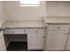 Functional kitchen desk area featuring white cabinets, drawers, and granite countertops at 83 Nyishol Way, Dallas, GA 30157