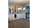 Dining room with built-in white shelving, chandelier and view to kitchen at 83 Nyishol Way, Dallas, GA 30157