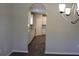 Elegant dining room with archway to the kitchen, featuring hardwood floors and a modern chandelier at 83 Nyishol Way, Dallas, GA 30157