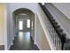 Inviting entryway with hardwood floors, staircase, and arched doorways offering a glimpse into other rooms at 83 Nyishol Way, Dallas, GA 30157