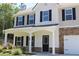 Charming two-story home with stone accents, a covered front porch, and a well-maintained landscaped yard at 83 Nyishol Way, Dallas, GA 30157