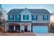 Charming two-story home with a welcoming front porch and a well-maintained lawn and two-car garage at 83 Nyishol Way, Dallas, GA 30157
