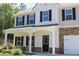 Beautiful home featuring a welcoming front porch, stone accents, and neatly trimmed landscaping at 83 Nyishol Way, Dallas, GA 30157