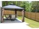 Backyard view of covered gazebo with patio furniture and privacy curtains, perfect for outdoor entertaining at 83 Nyishol Way, Dallas, GA 30157
