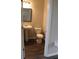 Powder room with pedestal sink, modern fixtures, and vinyl flooring at 83 Nyishol Way, Dallas, GA 30157
