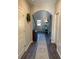 Hallway with arched entry, hardwood floor, rug, and furniture at 83 Nyishol Way, Dallas, GA 30157