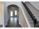 Inviting home entryway featuring a staircase with dark wood accents and an arched entrance to other rooms at 83 Nyishol Way, Dallas, GA 30157
