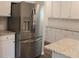 Stainless steel refrigerator with water dispenser and granite countertops in a modern kitchen at 83 Nyishol Way, Dallas, GA 30157