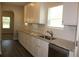 Kitchen counter with granite countertops, white cabinets, a stainless steel sink, and tiled backsplash at 83 Nyishol Way, Dallas, GA 30157