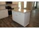 The kitchen features a center island with granite countertops and cabinetry for extra storage at 83 Nyishol Way, Dallas, GA 30157
