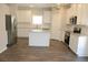 Spacious kitchen with modern appliances, granite countertops, a center island, and white cabinets at 83 Nyishol Way, Dallas, GA 30157