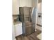 Modern kitchen features stainless steel refrigerator with granite countertops and white cabinets at 83 Nyishol Way, Dallas, GA 30157