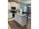 Modern kitchen features an island, stainless steel appliances, and granite countertops at 83 Nyishol Way, Dallas, GA 30157