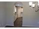 A view of the kitchenette from the dining room with white cabinets and granite countertops at 83 Nyishol Way, Dallas, GA 30157