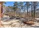 Large backyard patio with in-ground swimming pool, spa, and natural wooded views at 2250 Blackheath Trce, Alpharetta, GA 30005