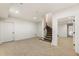 Basement featuring a carpeted floor, staircase, and a door leading to another room at 2250 Blackheath Trce, Alpharetta, GA 30005
