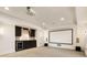Entertainment basement area features a screen, wet bar, speakers and recessed lights with neutral carpet at 2250 Blackheath Trce, Alpharetta, GA 30005