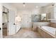 Bathroom featuring a soaking tub, glass-enclosed shower, double vanity, and travertine flooring at 2250 Blackheath Trce, Alpharetta, GA 30005
