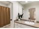 Bathroom featuring a single sink vanity, large mirror, and a shower with a brown curtain at 2250 Blackheath Trce, Alpharetta, GA 30005