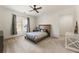 Bedroom with a platform bed, ceiling fan, carpet, and a window with modern blinds at 2250 Blackheath Trce, Alpharetta, GA 30005