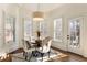 Bright breakfast nook boasts a modern chandelier and views of the outdoors at 2250 Blackheath Trce, Alpharetta, GA 30005