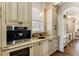 Practical butler pantry includes a beverage cooler, cabinets and a sink at 2250 Blackheath Trce, Alpharetta, GA 30005