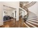 Grand foyer showcases a curved staircase, gleaming hardwood floors, and elegant archways at 2250 Blackheath Trce, Alpharetta, GA 30005