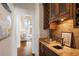Hallway wet bar features granite counters and wine storage at 2250 Blackheath Trce, Alpharetta, GA 30005