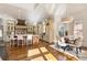 Open kitchen with large island, custom hood range, dining area, and hardwood floors at 2250 Blackheath Trce, Alpharetta, GA 30005
