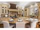 Gourmet kitchen features granite counters, custom cabinets, and an island with seating at 2250 Blackheath Trce, Alpharetta, GA 30005