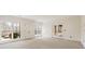 Spacious room with neutral carpet, recessed lights, double doors and multiple windows at 2250 Blackheath Trce, Alpharetta, GA 30005