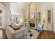 Cozy living room features a stone fireplace, built-in shelves, and glass coffee table at 2250 Blackheath Trce, Alpharetta, GA 30005