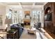 Bright living room with coffered ceilings, fireplace, and large windows offering picturesque views at 2250 Blackheath Trce, Alpharetta, GA 30005